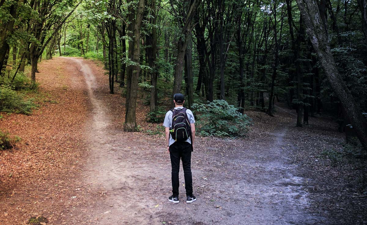 Man choosing which road to travel on