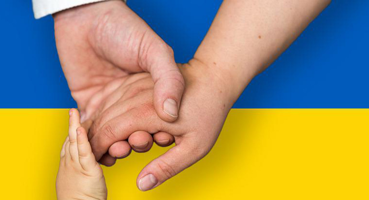 Ukrainian Flag with hands holding hands on top of it