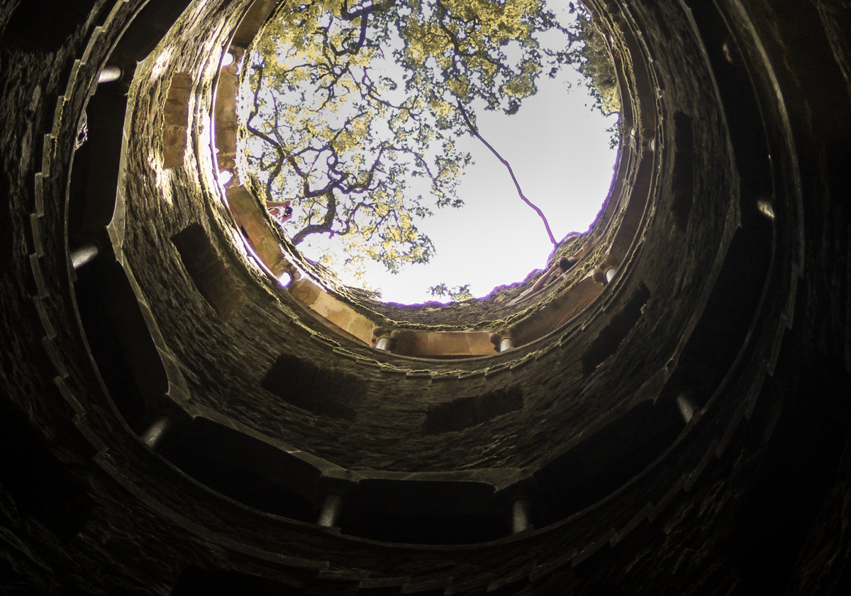 Looking up a water well with the sky in the distance