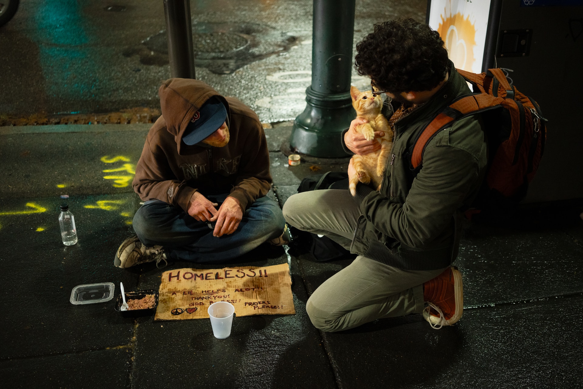Man begging with a cat