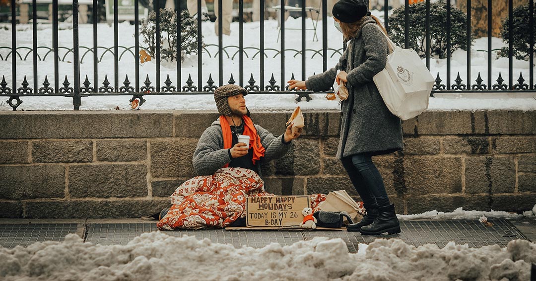 A woman giving support to a homeless person